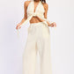 Cream-colored double gauze halter neck crop top with front knot and wide-leg trousers