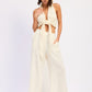 Cream-colored halter top with knot and high-waist palazzo pants set
