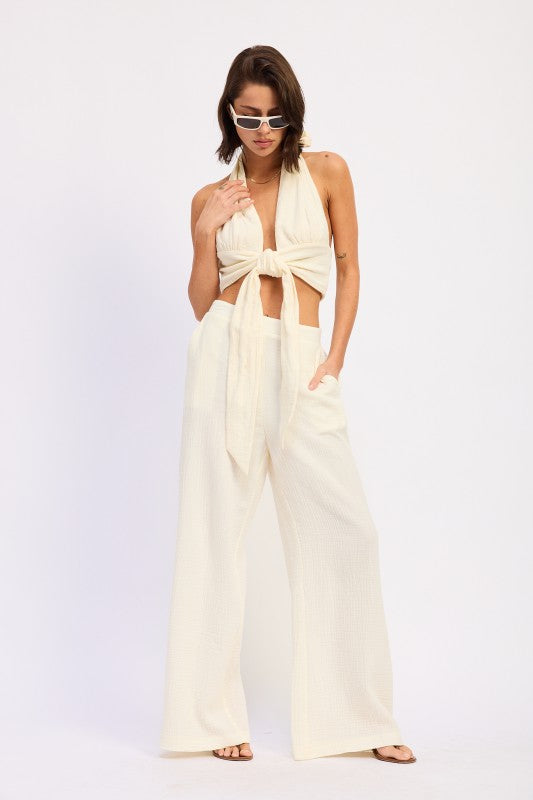 Cream-colored halter top with knot and high-waist palazzo pants set