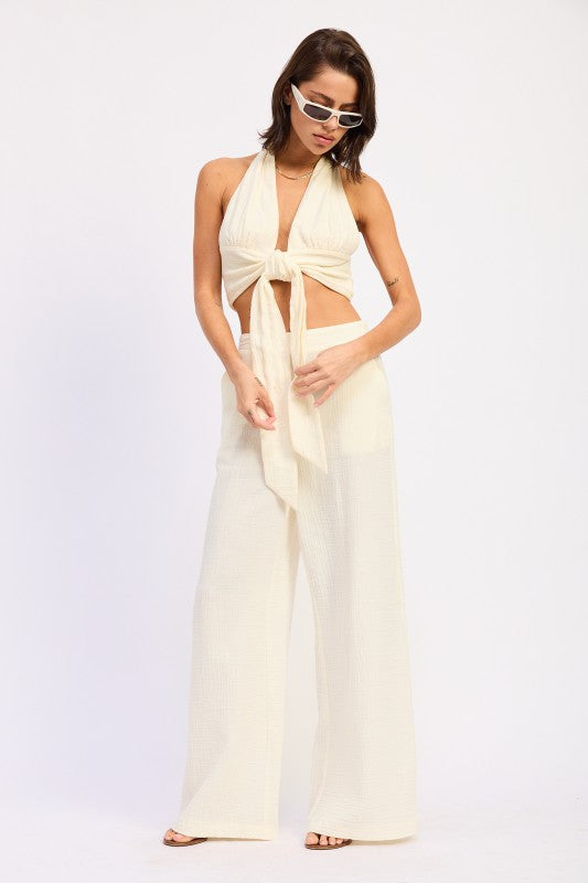 Cream halter top with front knot and high-waist palazzo pants
