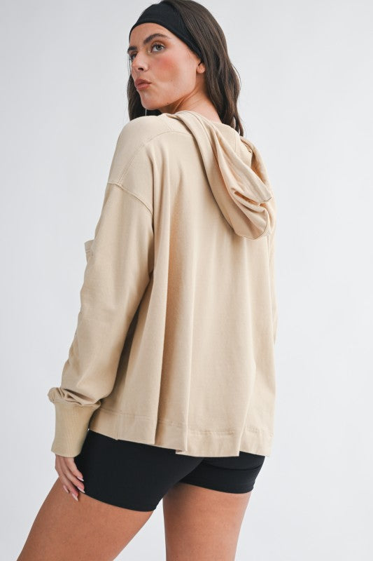 Beige relaxed pocket hoodie pullover top with oversized fit and ribbed cuffs