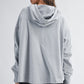 Relaxed pocket hoodie pullover top in heather gray with soft texture and ribbed cuffs