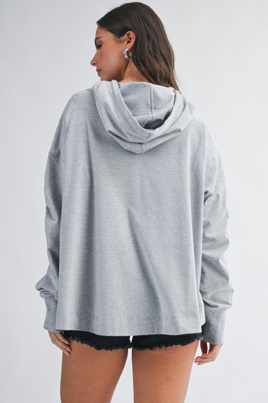 Relaxed pocket hoodie pullover top in heather gray with soft texture and ribbed cuffs