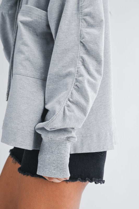 Gray heathered relaxed pocket hoodie pullover with ruched sleeves and ribbed cuffs