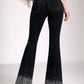 High waisted black denim boot cut jeans with silver rhinestone gradient on legs