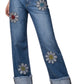 Junior Low Rise Rhinestone Daisy Jean with blue denim, embroidered smiling face floral patches and glittery details