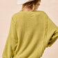 BiBi Boucle Rib Knit Uneven Hem Sweater in soft lime-green