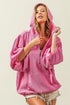 Pink corduroy hoodie with a half-zip front and puffy sleeves.