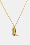Gold-toned cowboy boot pendant necklace with engraved details