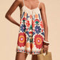 Vibrant off-white floral spaghetti strap romper with red blue orange blossoms