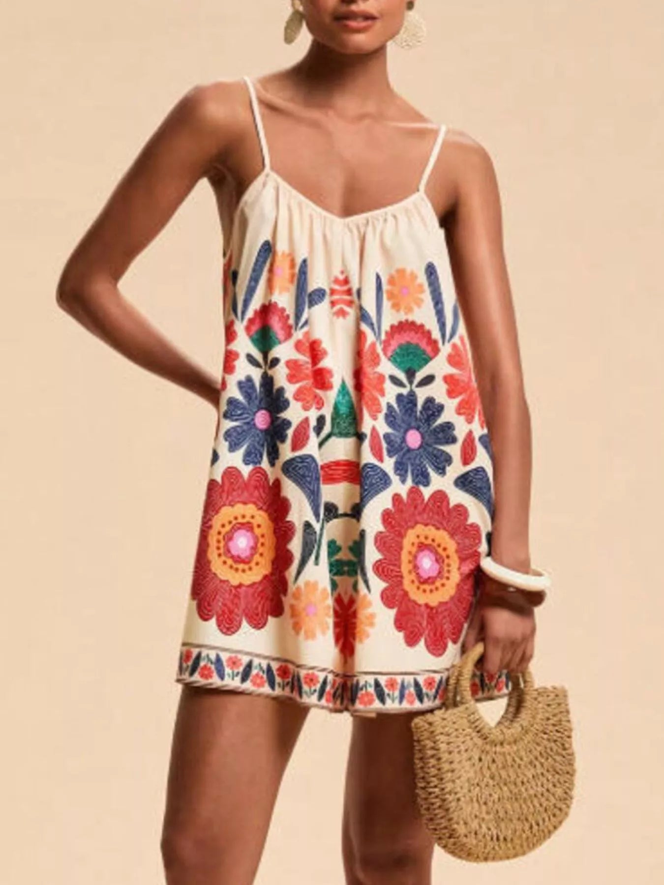 Vibrant off-white floral spaghetti strap romper with red blue orange blossoms