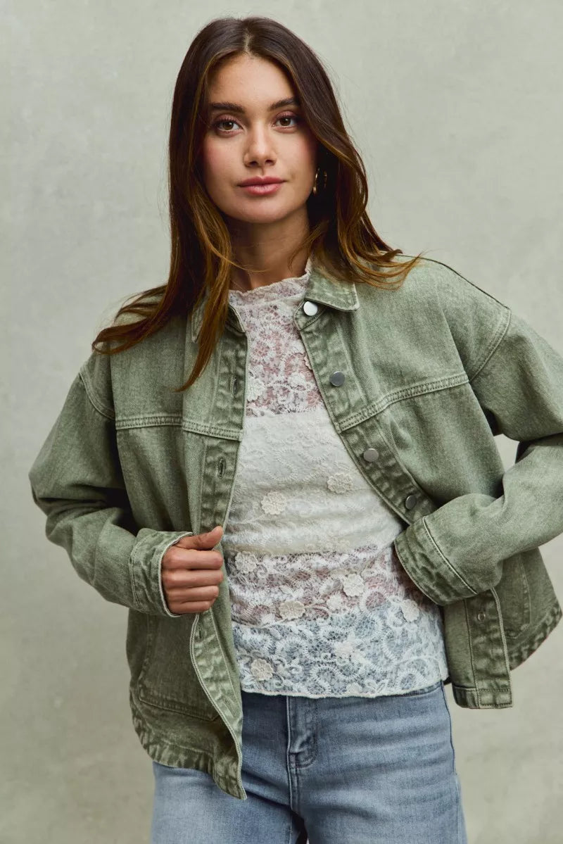 Vintage washed olive green denim shacket with button closures and frayed cuffs