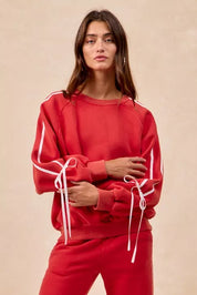 Red BiBi drawstring sweatshirt with white stripes and bow lace-up details