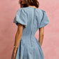 Back view of SO ME Bubble Sleeves light blue denim fit and flare mini dress with puffed sleeves and fitted back