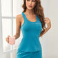 Turquoise sleeveless Daverri tank top with pocket and white piping