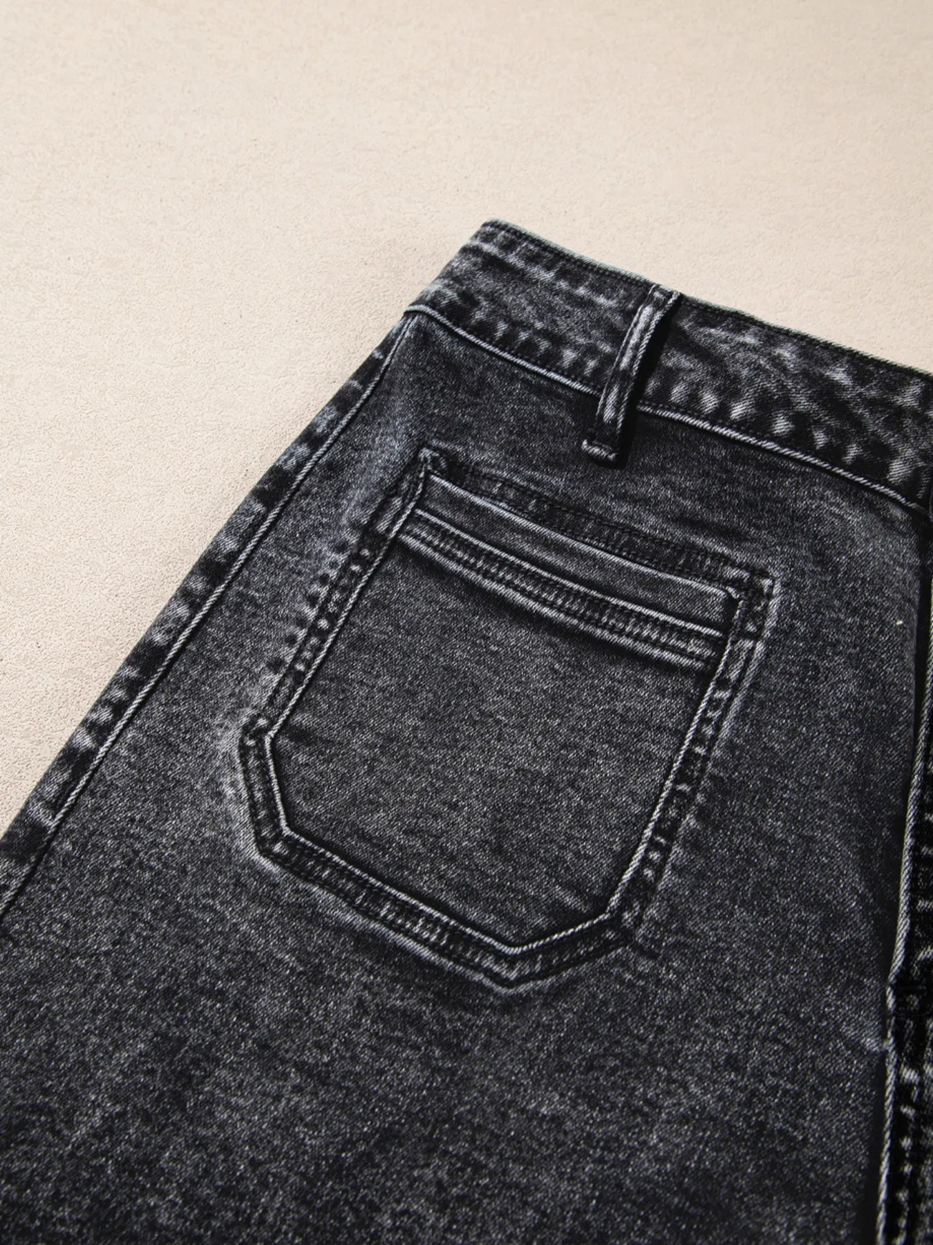 High-waisted wide leg washed jeans in dark gray denim with distressed finish and back pocket stitching