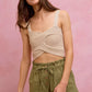 Beige knitted crop top with crossed front, thin straps on SO ME twill shorts