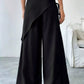 Daverri wrap-front wide-leg pants in black with draped asymmetrical front