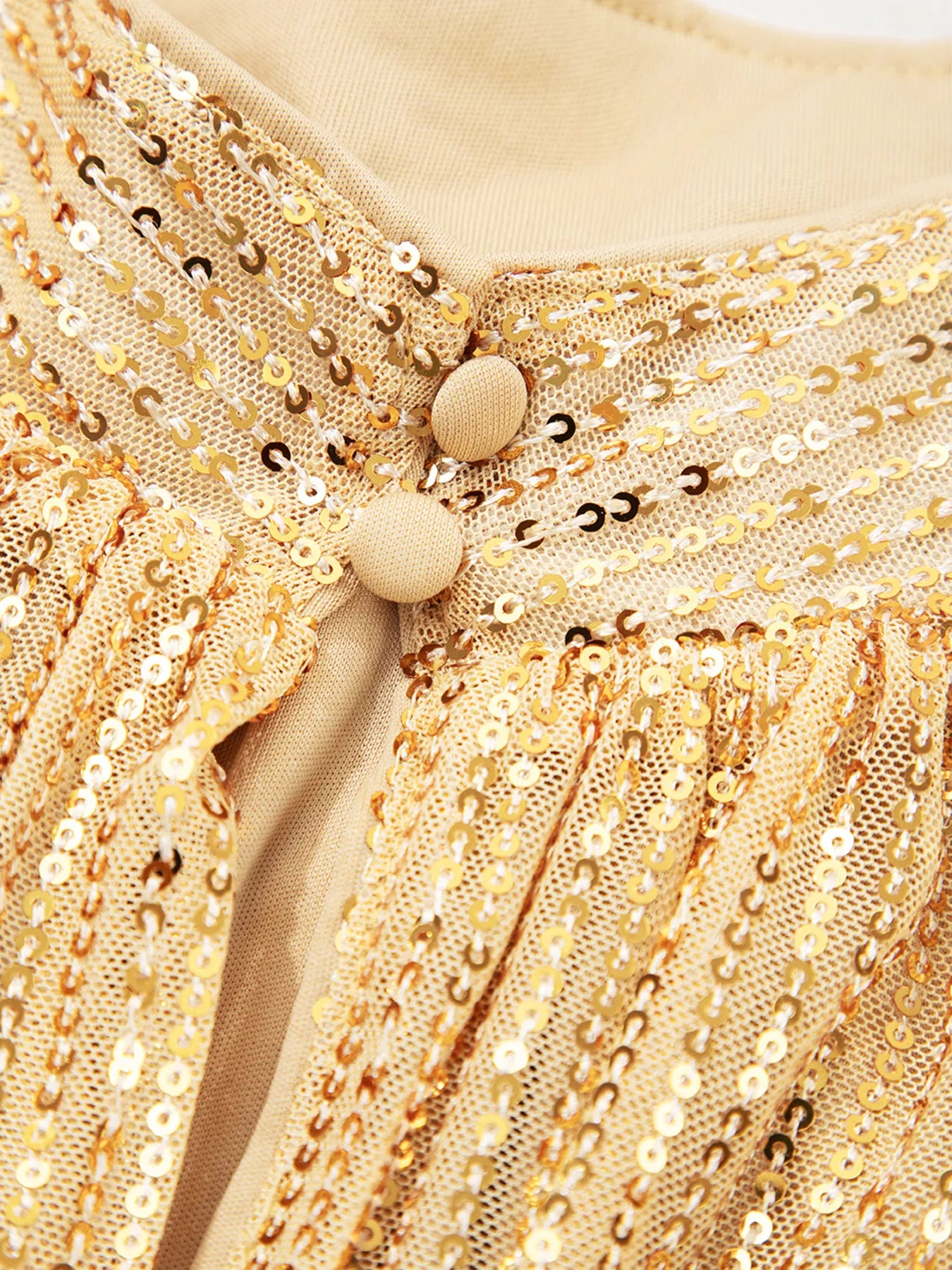 Gold sequined blouse with balloon sleeves, wooden buttons, ruffled hem