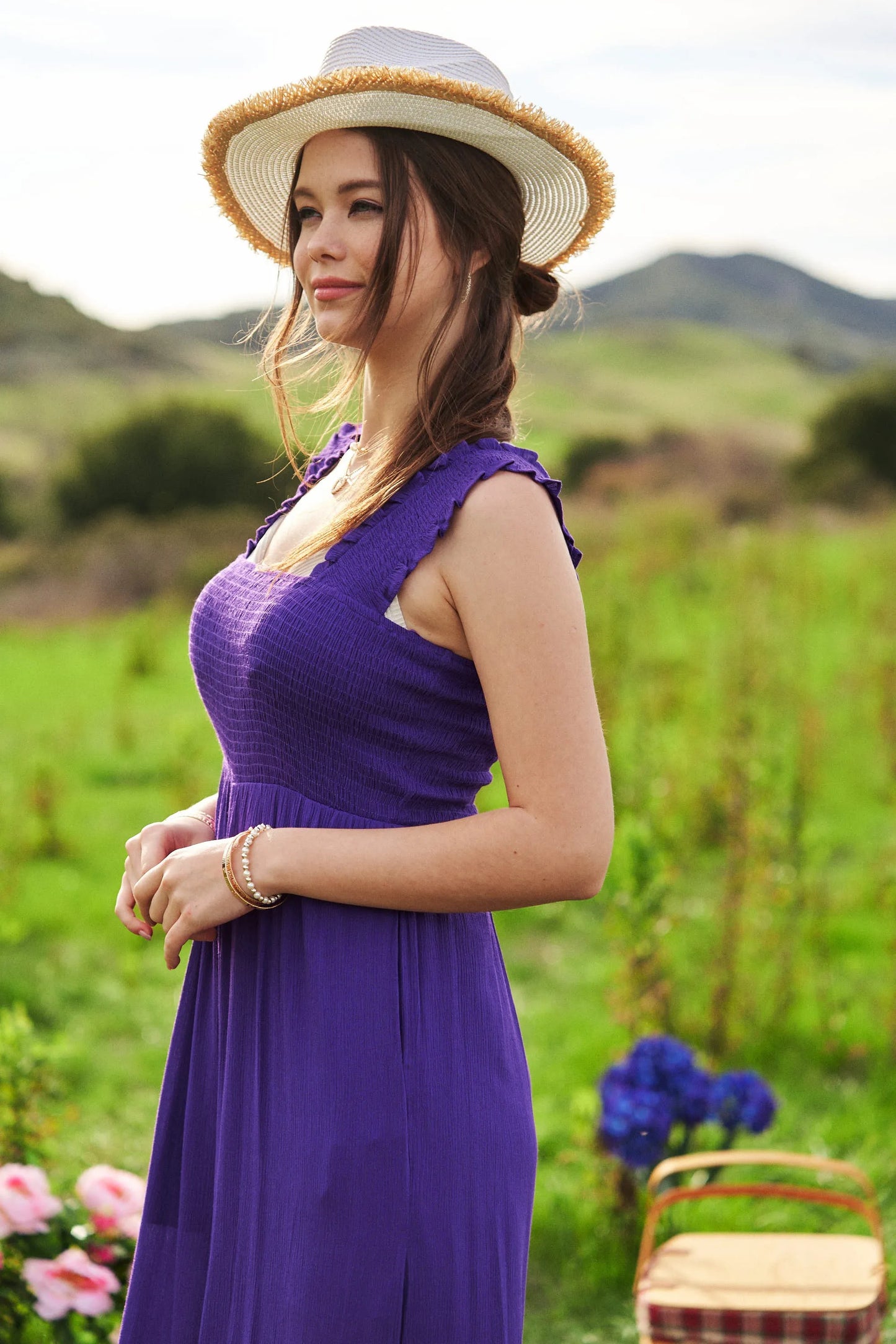 Woman in vibrant purple Davi & Dani smocked bodice ruffle jumpsuit