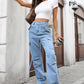 High-waisted light-wash denim cargo pants with pockets and side ties