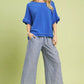 Blue Umgee linen top with ruffled sleeves and frayed hem