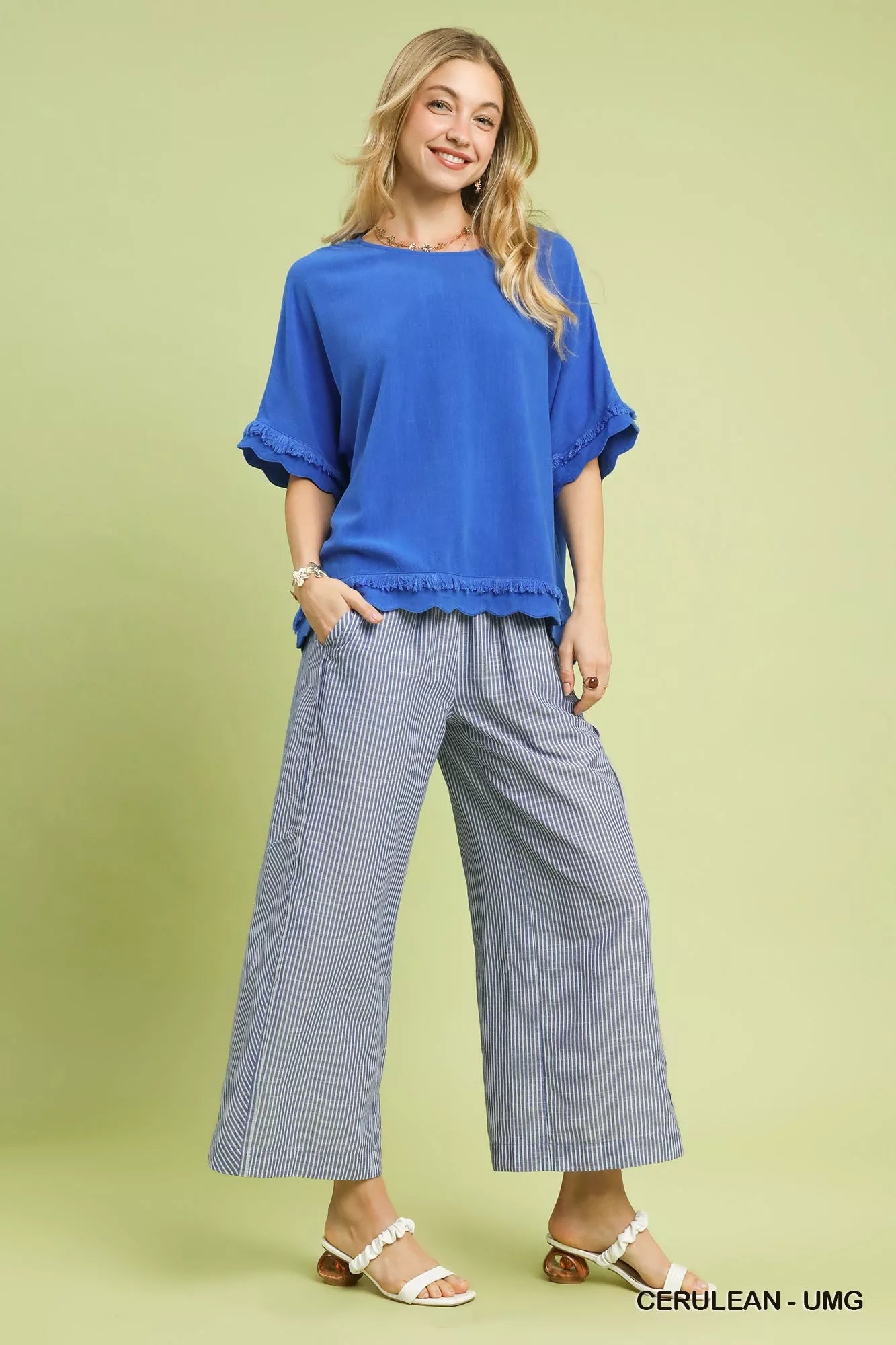 Blue Umgee linen top with ruffled sleeves and frayed hem