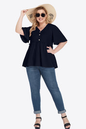 Plus size navy peplum blouse with V-neck, frill trim, and jeans