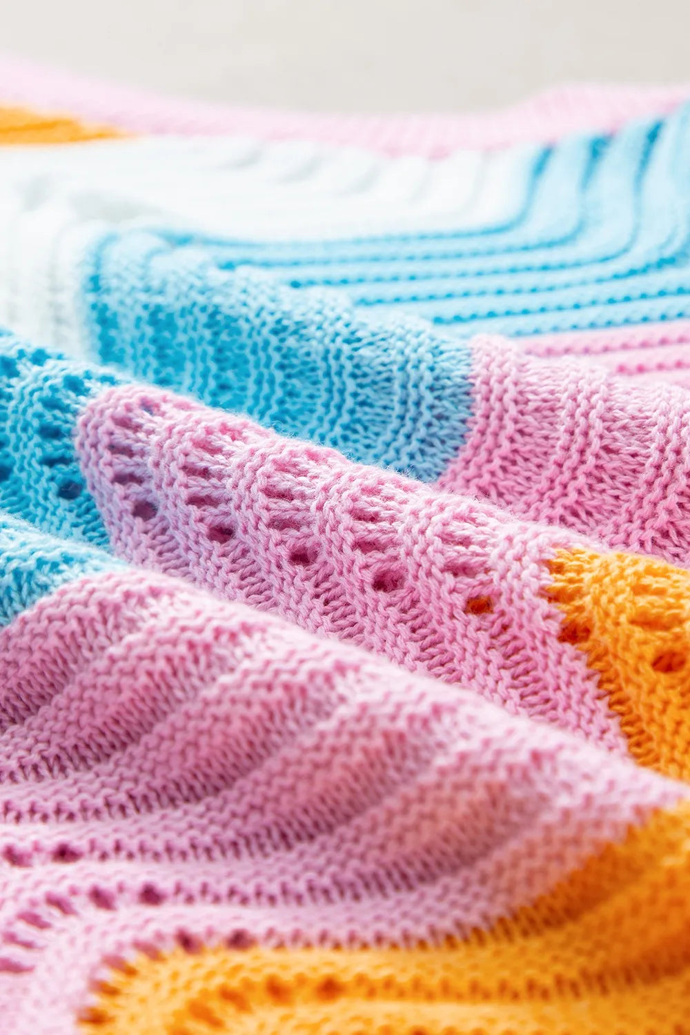 Pastel rainbow knit blanket with lace patterns in Daverri Fashions vest