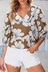 Brown floral blouse with white and light blue patterns, ruffled neckline, blue striped trim, and tie sleeves