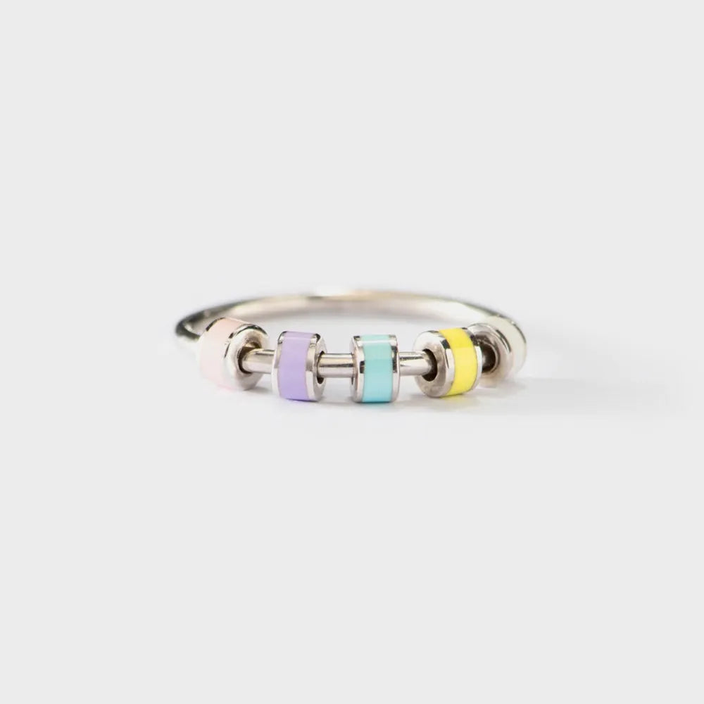 Silver ring with colorful cylindrical beads on a white background