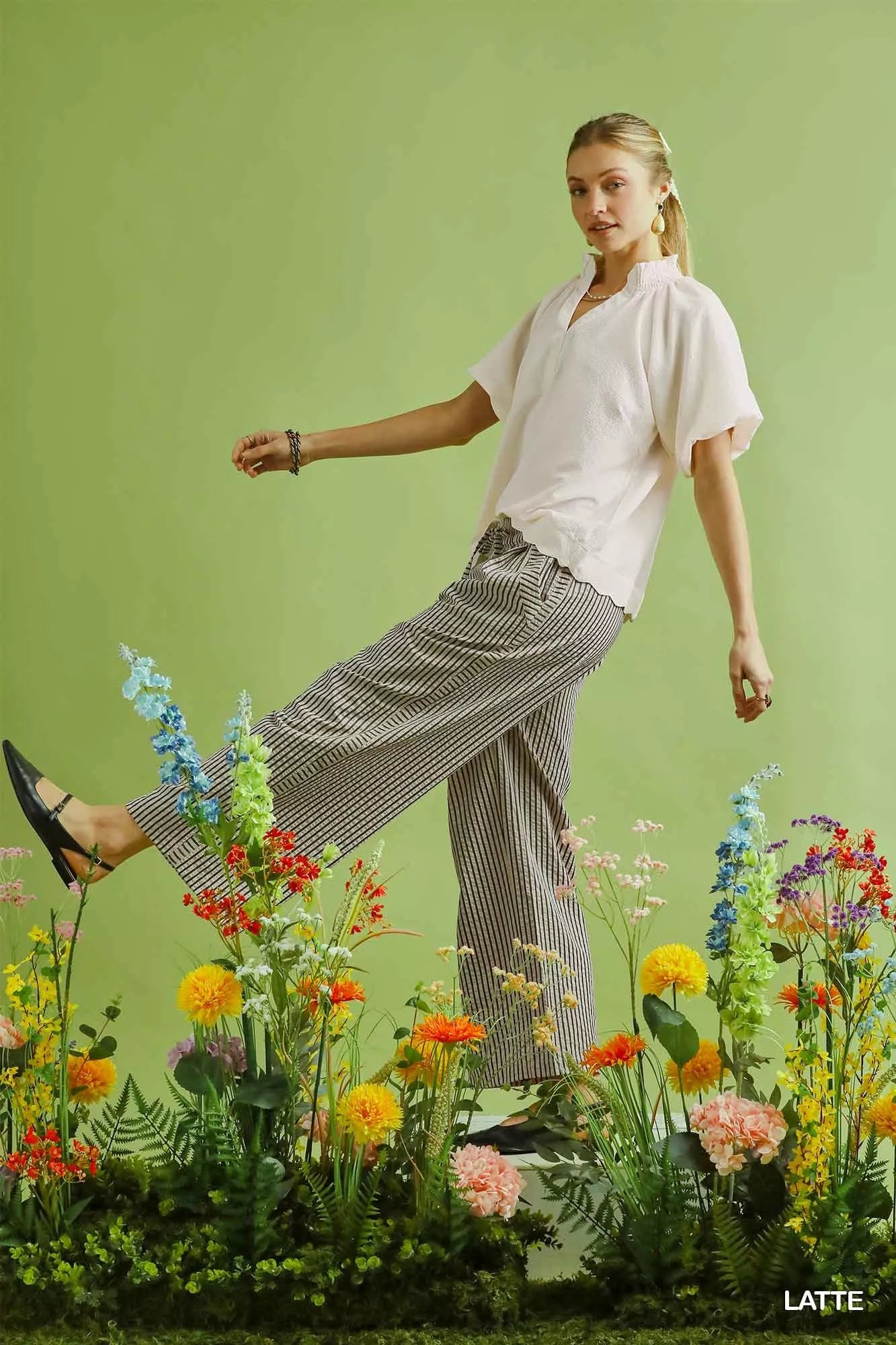 Woman in white blouse, Umgee drawstring striped wide-leg pants, black heels