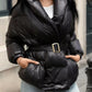 Daverri long sleeve belted puffer jacket in black with shiny quilted exterior and gold buckle