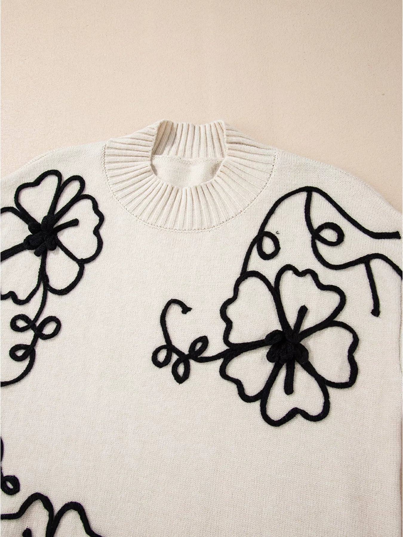 White floral embroidered blouse with black thread mock neck sweater