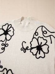 White floral embroidered blouse with black thread mock neck sweater