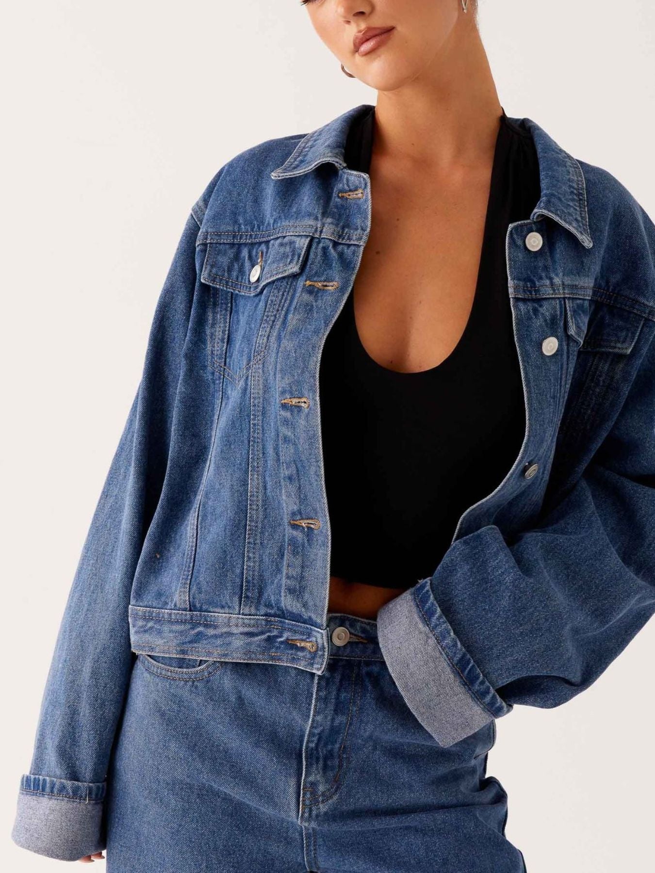 Daverri cropped oversized denim jacket in blue with rolled sleeves, silver buttons