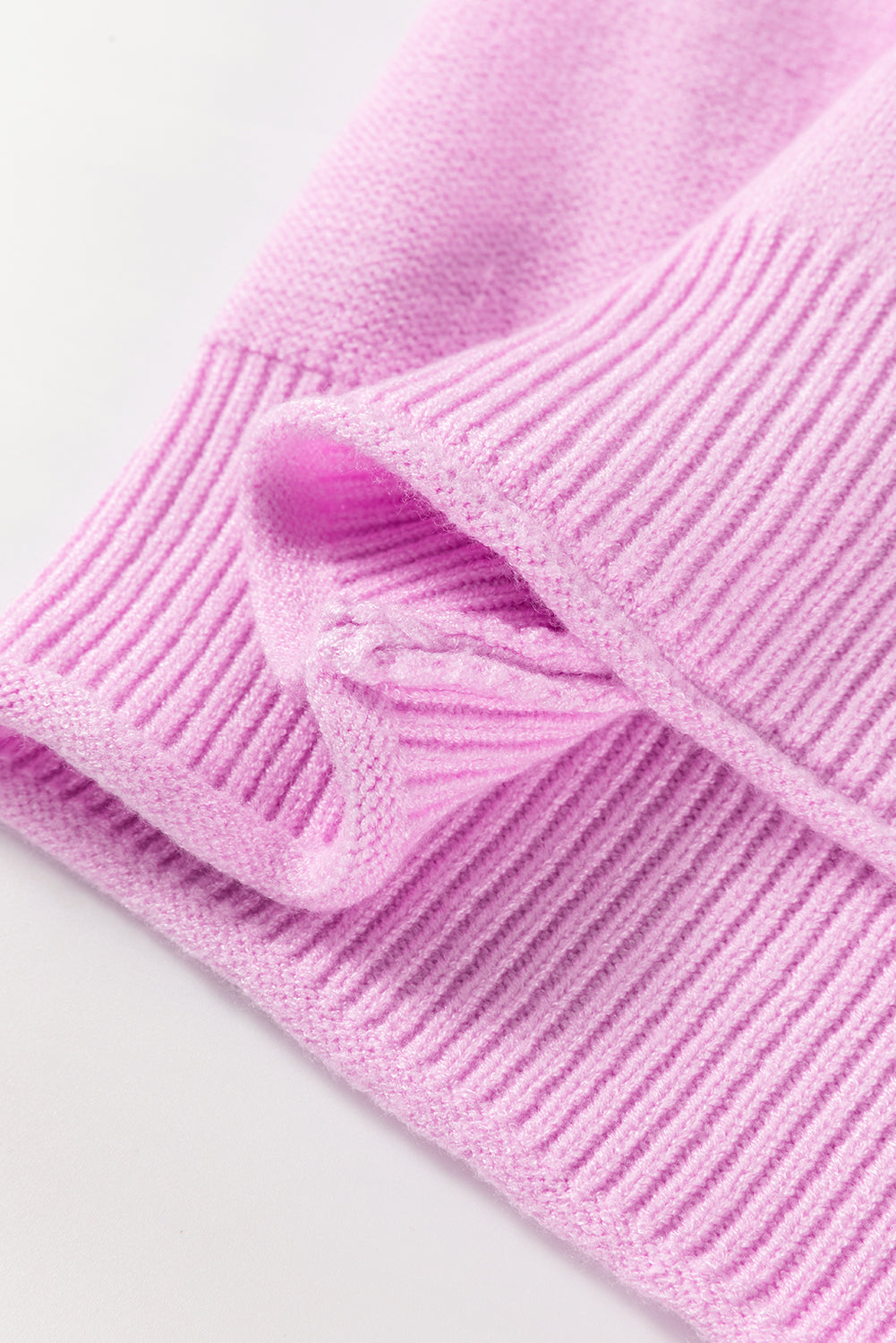 Pink raw edge ribbed knit sweater cuff with folded texture