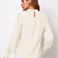 Cream-colored satin ruched mock neck blouse with puffed sleeves