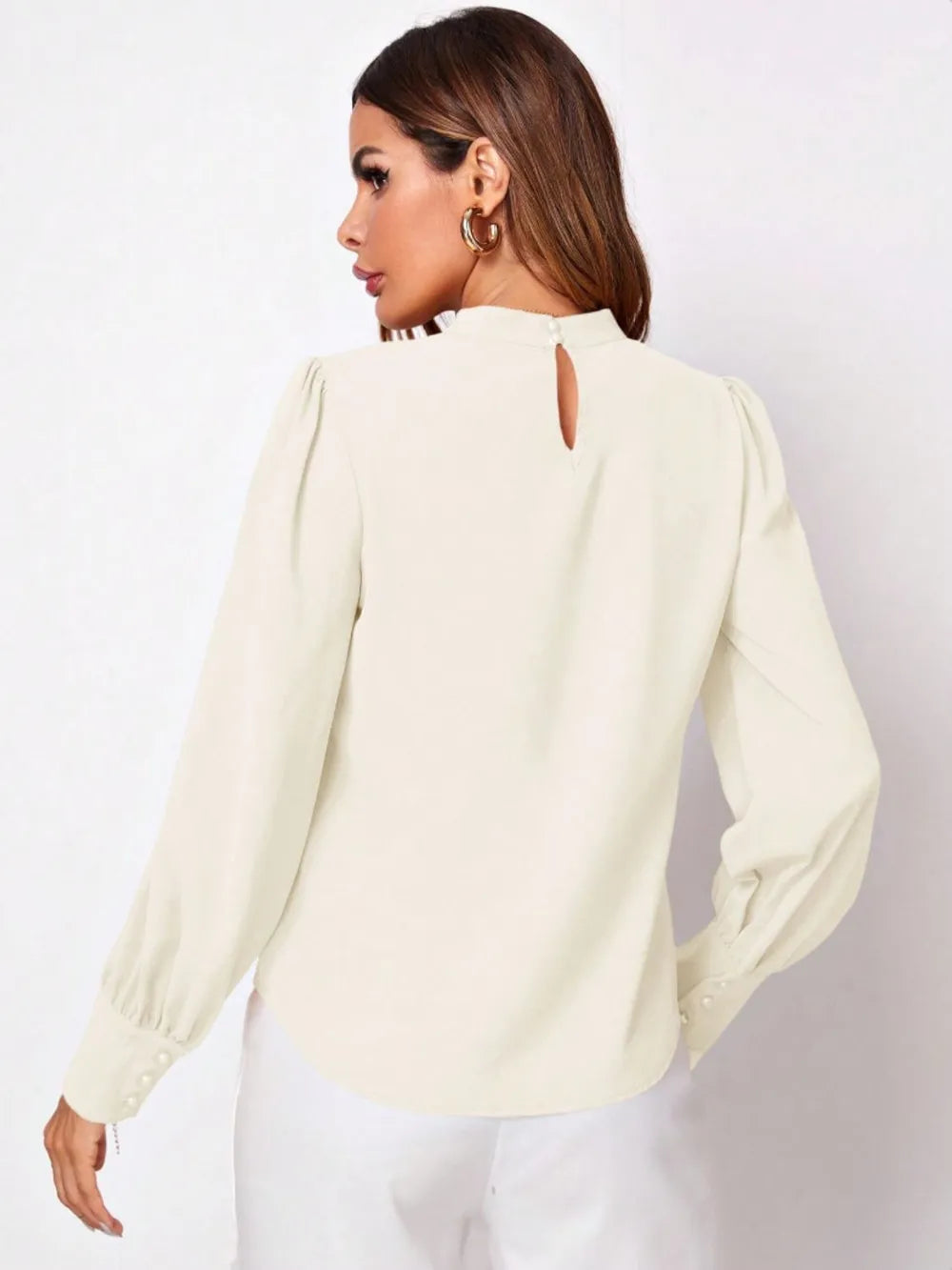 Cream-colored satin ruched mock neck blouse with puffed sleeves