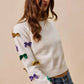 White SO ME Mardi Gras knit sweater with colorful sequined bows