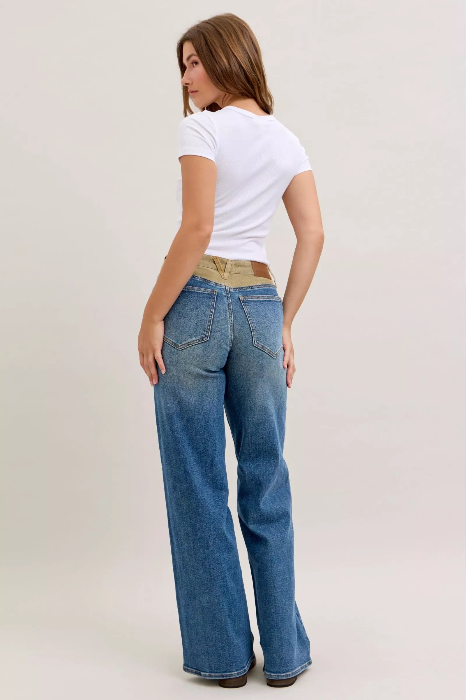Judy Blue mid-rise jeans with blue denim flare legs and tan corduroy waistband