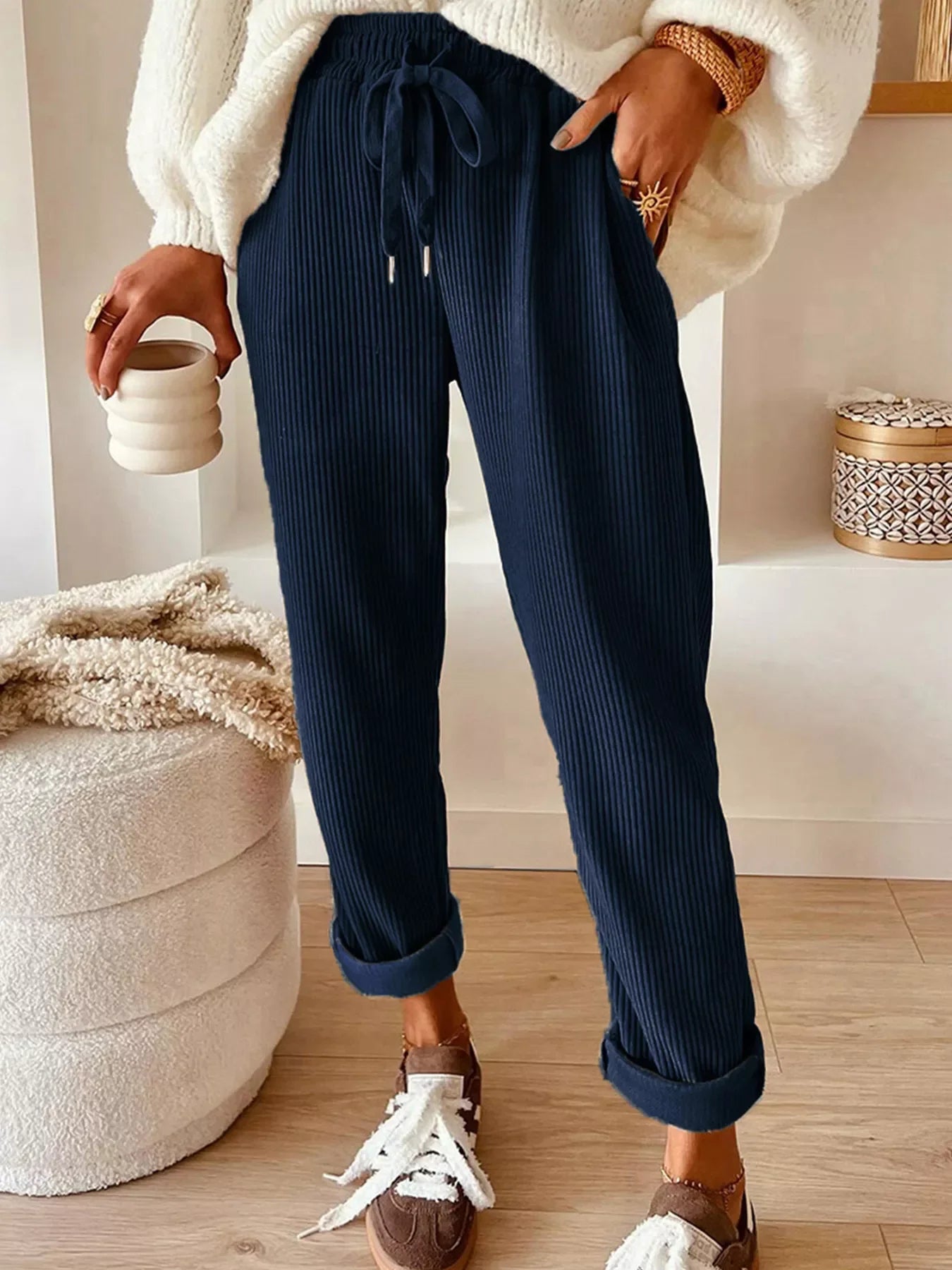 Navy blue corduroy tapered pants with rolled cuffs by Daverri Fashions