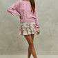 Soft pink cable-knit sweater with SO ME floral print skirt