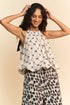 Davi & Dani ribbon checker printed tie halter neck blouse in off-white with black bow pattern and ruffled hem