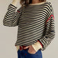 Black and white striped round neck long sleeve knit sweater with red trim
