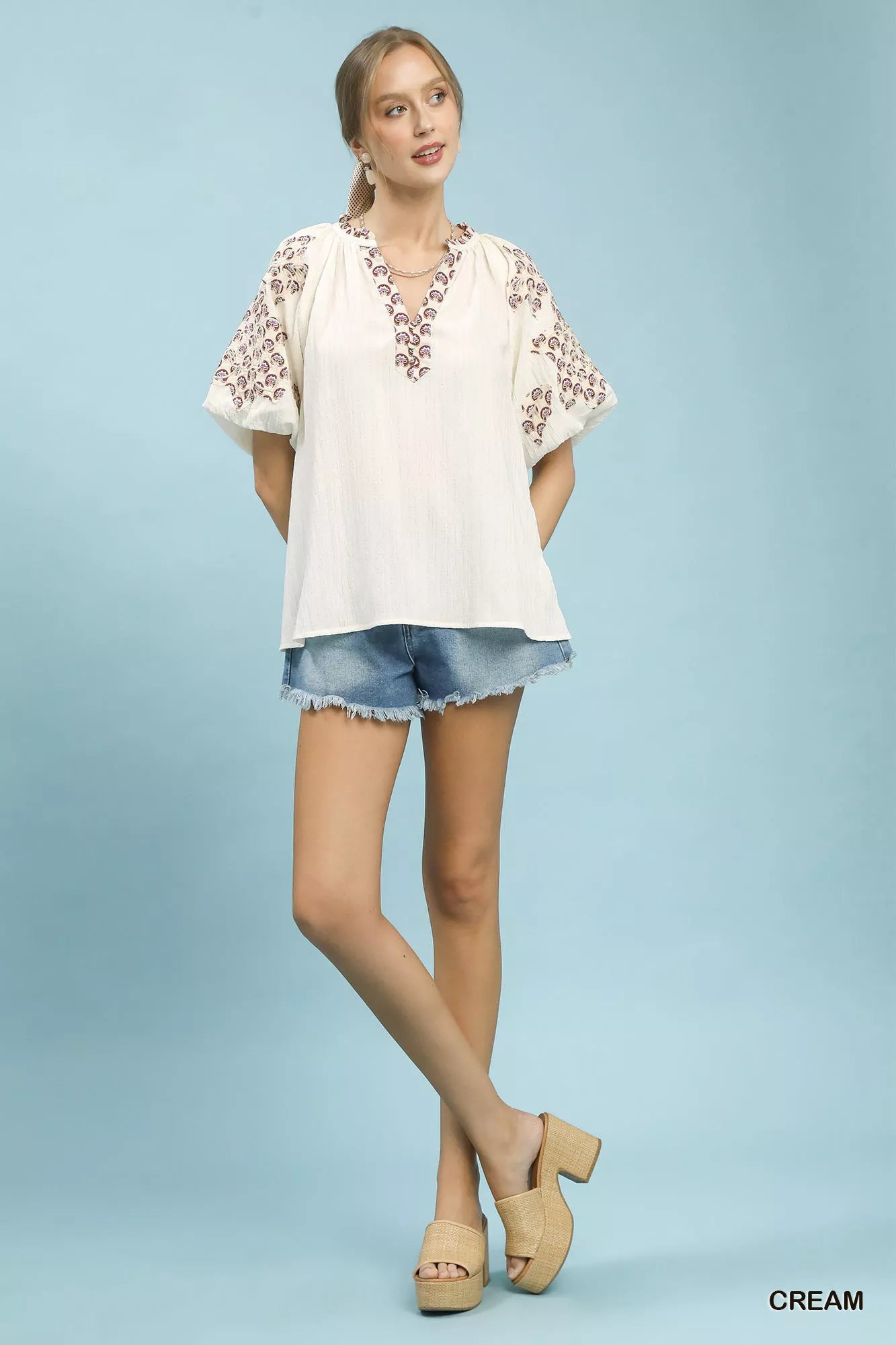 Umgee embroidered sleeve contrast trim top in cream with floral patterns