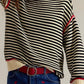 Black and white striped round neck long sleeve sweater with red trim
