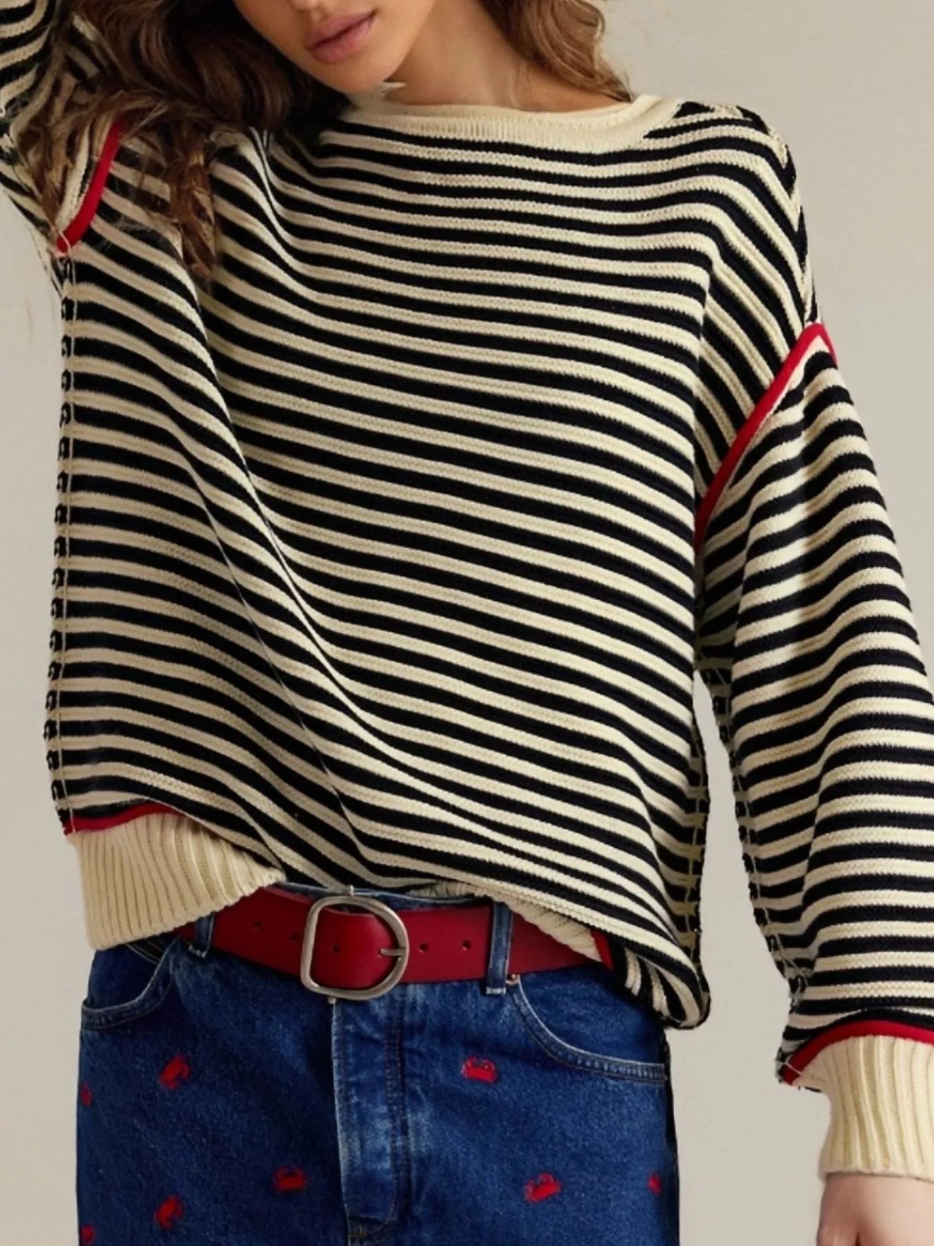 Black and white striped round neck long sleeve sweater with red trim