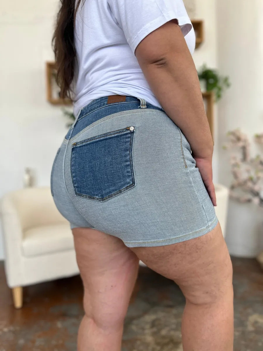 Back view of Judy Blue Full Size Color Block Denim Shorts with light-wash denim, dark blue pocket and brown leather belt loop