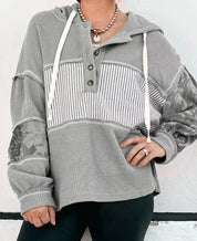 Grey waffle-knit hoodie with floral sleeves and drawstring hood